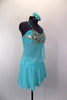 Aqua chiffon costume has silver sequins on bust of open sided baby-doll top. Skirt has layers of aqua chiffon over briefs. Comes with floral hair accessory. Right side