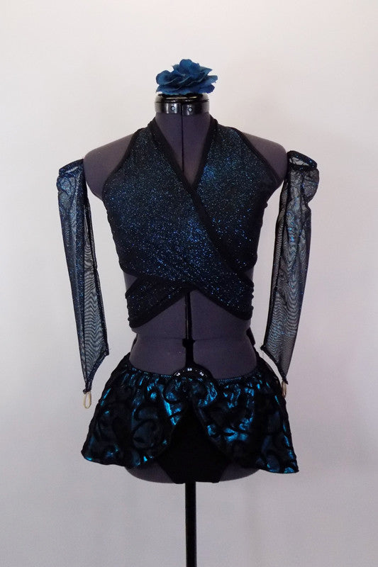 Teal and black sparkle top is a wrap-around bra with halter neck. Has black briefs, matching gauntlets and a teal and black swirled pull on mini hip skirt. Comes with floral hair accessory. Front
