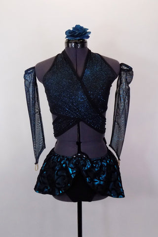 Teal and black sparkle top is a wrap-around bra with halter neck. Has black briefs, matching gauntlets and a teal and black swirled pull on mini hip skirt. Comes with floral hair accessory. Front