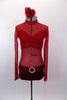 Sheer red short crystaled unitard has long sleeves & red velvet bottom with crystal buckle accent . There is an attached red velvet bra beneath the sheer. Comes with floral hair accessory. Front
