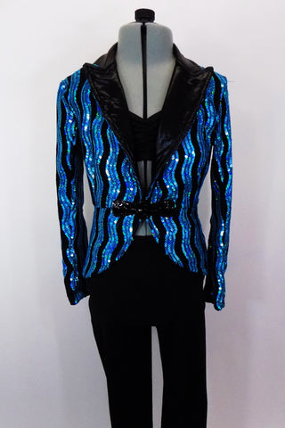 Sequined lined blazer has shimmering black lapels and fancy jeweled front clasp. It sits over a black bra top. Comes with black leggings and hat accessory. Front
