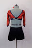 Two piece costume has navy high-waisted shorts with gold buttons. The red open back, long sleeved crop-top has sequined stripes. Comes with bow hair accessory. Back