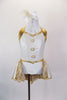 Gold & pearl white leotard dress has crystal covered halter collar, large pearl buttons & an open front bustle skirt with golden lace. Comes with hair accessory. Front