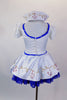 White sailor dress has princess cut seams, pouf sleeves and gold sailor buttons and hand painted anchor design over blue lace petticoat. Comes with sailor hat. Back