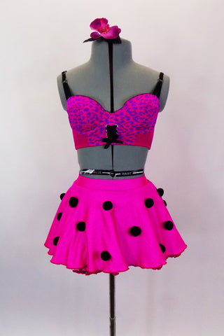 Hot pink skirt has ruffled petticoat with black pom-pom accents. Matching pink & purple leopard print bralette has tie front detail.  Comes with hair accessory. Front