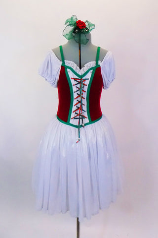 White ballet dress has pouf sleeves, sheen chiffon skirt over white tulle & red velvet vest bodice with green piping & lace-up front design. Has hair accessory. Front