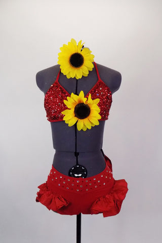 Two piece red costume has beaded triangle bra-top with large center sunflower. Ruffled brief has crystaled waistband & large back bow. Has sunflower hair piece. Front