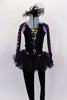 Black velvet unitard has black tutu skirt. Legs and sheer arms have colorful design lined with crystals. Bodice had low V-front held by straps & ruffled collar. Comes with hair accessory. Front