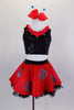 Ladybug themed costume has red skirt with large crystaled blue dots over layers of black lace petticoat. Comes with black sequin top & matching hair accessory. Front