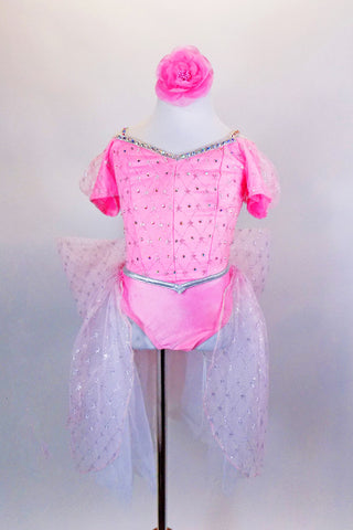 Pink leotard dress has lace overlay & piping covered with Swarovski crystals. Bustle is white-pink tulle, with large bow on behind. Comes with hair accessory. Front