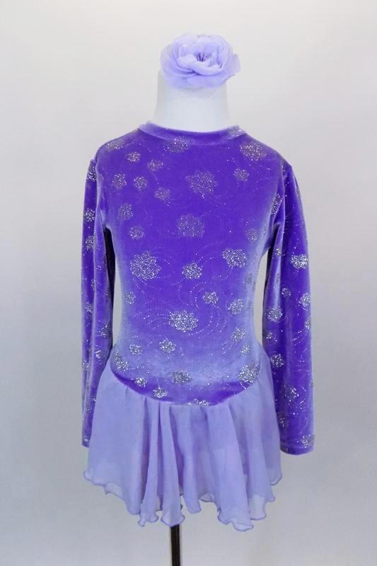 Lavender velvet skaters dress has long sleeves, high neck, and keyhole back & accents of silver flowers. The attached skirt is layers of pale lavender chiffon. Comes with hair accessory. Front