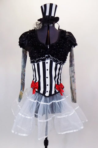 Black & white striped jacket has red bows, black  fur & tattoo sleeves with pouf.  Has white crystal tulle skirt with ribbon accent, attached black shorts & matching mini striped top hat. Front