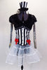 Black & white striped jacket has red bows, black  fur & tattoo sleeves with pouf.  Has white crystal tulle skirt with ribbon accent, attached black shorts & matching mini striped top hat. Front