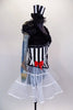 Black & white striped jacket has red bows, black  fur & tattoo sleeves with pouf.  Has white crystal tulle skirt with ribbon accent, attached black shorts & matching mini striped top hat. Right side