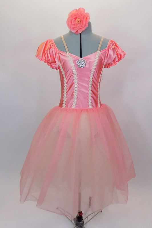 Romantic ballet tutu has layers of white tulle with peach overlay. The attached satin bodice has cream braiding along princess seam. Comes with floral hair accessory. Front