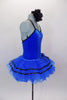 Royal blue ballet tutu has layers of blue ruffled tricot with black ribbon accented. The attached blue velvet bodice has black cross straps. Comes with floral hair accessory. Right side
