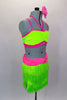 Neon green fringe skirt has pink gathered waistband with crystal buckle. Matching half-top has  pink leatherette banding and straps. Comes with hair accessory. Right side