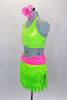 Neon green fringe skirt has pink gathered waistband with large crystal buckle. Comes with matching green racerback half-top & hair accessory. Left side