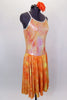 Orange & yellow dress has knee length flowing skirt with silver swirl detail. The bodice is an iridescent camisole with silver edging. Comes with hair accessory. Side