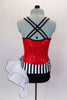 Biketard has red sequin bodice with black double cross straps,. Accented with black & white stripe waistband, large white curly side bustle, attached black shorts & hair accessory. Back