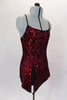 Classy red sequined tunic dress has black cross straps that dips into criss-cross  accent. The front comes to a point with center slit to create an elegant look. Comes with attached spandex briefs. Right side