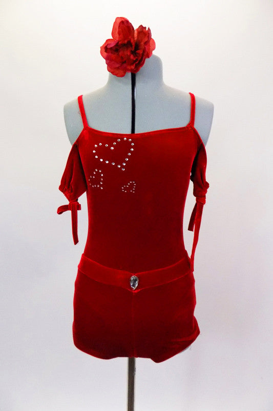 Red velvet leotard has off shoulder gather sleeves with ties & velvet shoulder straps. Bodice has three crystal hearts. Comes with shorts and hair accessory. Front