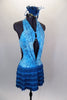 Aqua open front leotard dress has turquoise swirls. The open back halter bodice has front lapelled panels and crystaled back straps. Skirt is five layers of turquoise fringe. Comes with hair accessory. Right side