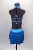 Aqua open front leotard dress has turquoise swirls. The open back halter bodice has front lapelled panels and crystaled back straps. Skirt is five layers of turquoise fringe. Comes with hair accessory. Back