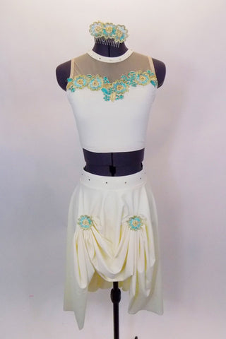 Two-piece costume has cream half top with nude mesh upper, crystals & embroidered turquoise applique. The matching skirt has gathered front with appliques. Comes with matching hair accessory. Front