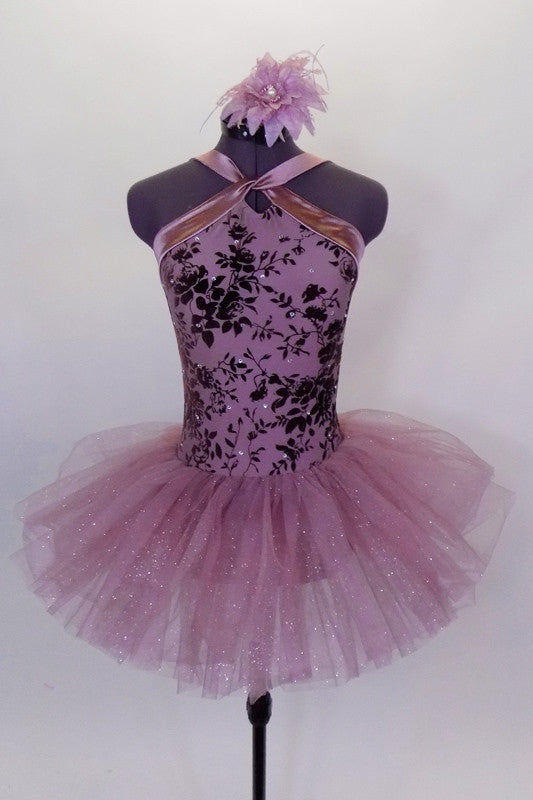 Pale mauve tutu dress has crystal tulle skirt attached to a mauve sateen bodice with wrap halter neck & plum velvet floral design. Comes with floral hair accessory. Front