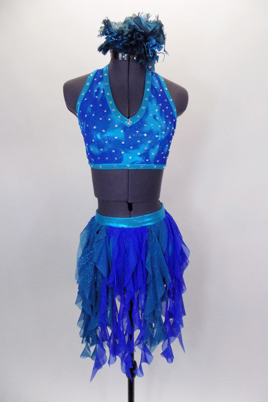 Costume is a halter neck, open back half top with splashes of blue-green & crystals. Bottom is brief with skirt of dangling mesh swirls. Has hair accessory. Front