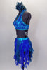 Costume is a halter neck, open back half top with splashes of blue-green & crystals. Bottom is brief with skirt of dangling mesh swirls. Has hair accessory. Left side