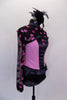 Three piece costume has pink & black corset top with pink hearts & bow at back. The sheer black shrug also has pink hearts. Comes with feather hair accessory. Right side