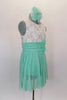Empire waist dress has ivory lace bodice & shirred cummerbund with feather accent. Skirt is layers of mint green glitter mesh. Has matching hair accessory. Right side