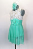 Empire waist dress has ivory lace bodice & shirred cummerbund with feather accent. Skirt is layers of mint green glitter mesh. Has matching hair accessory. Left side