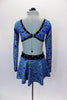 Blue glitter swirl, long sleeved V-neck top has black crystaled trim attached to black velvet shorts with matching bustle skirt. Comes with hair accessory. Back