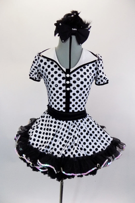 Black-white polka dot leotard has keyhole back, lapel collar & pearl buttons. Skirt has black petticoat with large back bow. Comes with gloves & hair accessory. Front