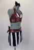 Red sequin halter style bra with white accents and black crystaled V straps is complimented by skirt with fabric piano keys & red sequined waistband & back bow. Comes with black hair bow clip and long black gloves. Side