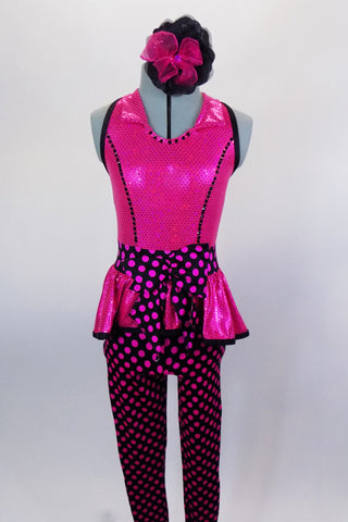 Hot pink crystaled princess cut halter neck bodice with black edge, has peplum and polka dot bow waistband. The attached leggings are black with fuchsia dots. Comes with matching hair accessory. Front