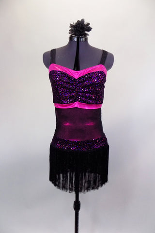 Flapper style dress has black glitter fringe with hot pink sequined waistband, banding & bust. The back is speckled mesh. Comes with hair accessory. Front