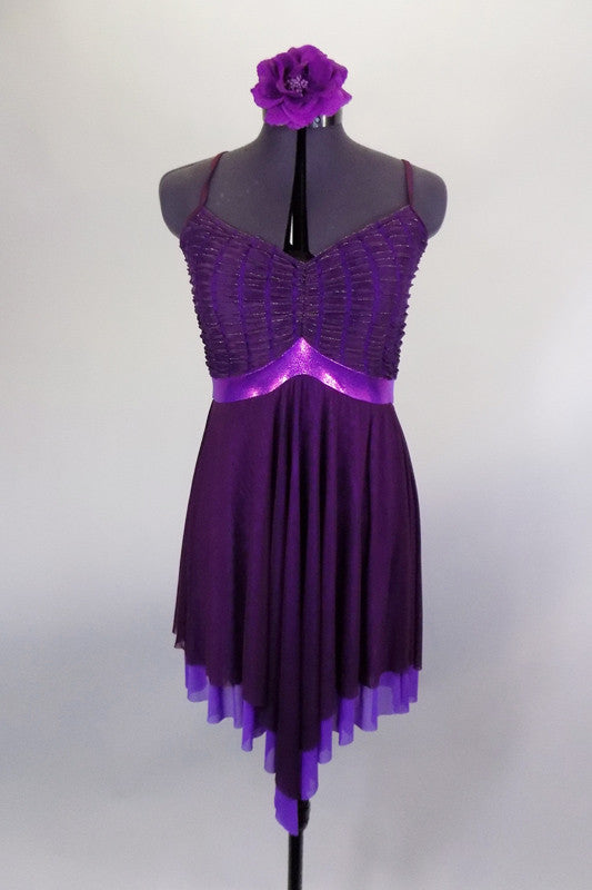 Eggplant dress has leotard base with cross straps & fine pleated gold-flecked bodice with pinch front. Dress has purple metallic band below the empire waist. Comes with floral hair accessory. Front