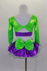 2- piece costume has purple glitter ruffle skirt with large green back bow and layers of white curly hem petticoat. Long sleeved green top has purple center. Comes with crystal buckle accent and purple hair bow. Back