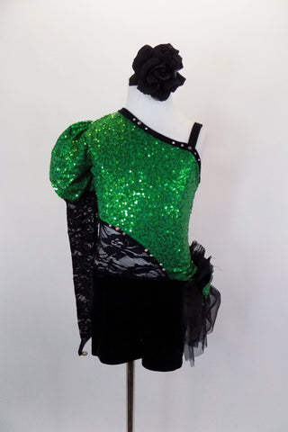 Green sequined asymmetrical one sleeve costume with pouf & lace. One side is cut-out with black lace. Black velvet shorts have sequined bow ruffle accent on hip. Comes with hair accessory. Front