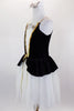 Black & white romantic tutu dress has skirt in layers of white tulle. The black velvet peplum bodice has white center panel with applique & gold braid accent. Comes with matching hair accessory. Left side