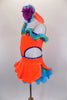 Bright orange velvet one-shoulder dress has open sides with purple crystals. Curly hem ruffles in lime, turquoise & purple accent the neckline & petticoat edge. Comes with ruffled gauntlets and floral headband. Left side