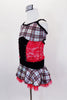 Red, black & silver tartan school-girl costume has tartan bust and skirt attached by red sequined lace torso with crystaled black velvet center and waistband. Comes with crystal air barrette. Side