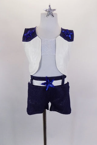 Costume has white bra top & denim shorts with star appliqued back pockets & white faux leather belt and vest. Vest has denim upper & blue applique stars. Front