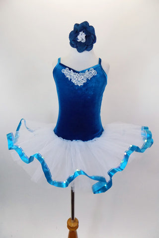 Teal velvet ballet tutu dress with beaded applique has attached white tulle bottom with teal ribbon edge Back has a design of looping cross straps. Comes with matching floral hair accessory. Front