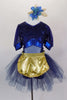 Navy blue, open backed dress has lace overlay with mesh center & pouf sleeves. Skirt is navy tulle with attached shorts. Comes with  gold apron & hair accessory. Front