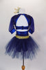 Navy blue, open backed dress has lace overlay with mesh center & pouf sleeves. Skirt is navy tulle with attached shorts. Comes with  gold apron & hair accessory. Back